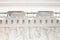 White Cornice and frieze close-up, angels bas-relief. Classic elements of facade decoration, ancient architecture, front view