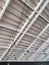 White corrugated metal ceiling with exposed light bulbs