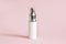 White cosmetic products tube. Blank plastic container for cream, lotion, toothpaste, nourishing or moisturizing mask on a pink bac