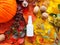 White cosmetic spray bottle, red perfume bottle, pumpkin, magic lights and bright autumn leaves. Natural organic spa cosmetics and