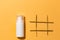 White cosmetic tube without brand with hashtag on orange background, best summer treatment for healthy skin