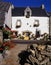 White cottage with hanging baskets, Brittany, France