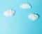 White cotton clouds on pastel blue background. Minimal concept