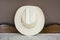 A White Cowboy Hat on an Antique Cabinet Front View