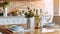 White Cozy Kitchen Table at Home Provence Interior. Champagne Bottle for Honey Dinner Date on Light Wooden Counter. Cozy