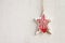 White craft star Christmas decoration hanging on background horizontal