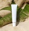 white cream tube with copy space. beach background daylight concept. cosmetic package for advertising.