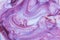 White creame yoghurt, ice cream mixing with violet blueberry taste. Texture background photo