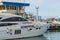 White crew boat `Elbrus` of Black Sea by pier of Commercial seaport of Sochi. Resort city center.