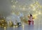 White crocheted deer Rudolph, Santa Claus and various Christmas decorations, illuminated white light chain background, Christmas