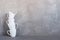 White crockery on the table against the textured grey wall