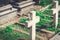 White cross on the grave in the old cemetery. Small plaster figures of angels on the cross