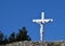 White cross with Jesus with blue sky