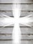 White cross with light rays and old wooden grey background christian symbol of resurrection