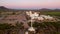 White cross overlooks Mission San Xavier in Tucson, Arizona. Drone shot