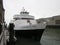 A white cruise boat, Alcatraz Flyer, near Alcatraz Island, a historic prison landmark and tourist attraction, in San Francisco.