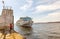 the white cruise ship `Great Rus` approaches the Samara railway station on a spring sunny day. The text in Russian: Russia is g