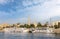 White cruise ships on the Nile in front of the city of Luxor in sunshine.