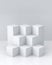 White cube boxes with white blank wall background for display. 3D rendering.