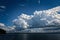 White Cumulus cloud in blue sky at sea.