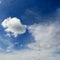 White cumulus clouds against the background of an epic blue sky.