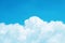 White cumulus clouds against a bright azure sky background, ton