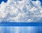 White cumulus clouds over sea close up blue sky background landscape, big fluffy cloud above ocean water panorama, cloudscape