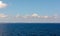 White cumulus clouds in sky over blue  water of Gulf of Finland landscape