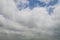 White cumulus clouds under blue sky