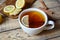 White cup of black natural tea with ginger, lemon and honey. Healthy Antiviral drink. Hot winter beverage concept.