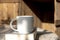 White cup with cappuccino coffee and books on an table with a background of old rustic woods