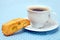 The white cup of coffee with biscotti