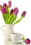 White cup of coffee with bunch of purple tulips on whit