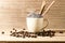 the white cup of coffee and coffee beans seed with broen sugar a