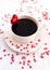 White cup of coffee decorated with red heart