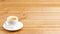 White cup of coffee espresso on wooden background. Shallow focus. Angle view.