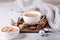 White cup with coffee and marshmallow, sweater, cinnamon. Cozy christmas composition. Hygge concept Soft focus