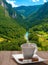 White cup of coffee on a saucer.View of the Tara river canyon.