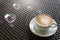 White cup of coffee on table and heart bubbles