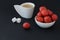 White cup of coffee, two pieces of sugar and little round plate with juicy tasty strawberries,