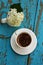 White cup with coffee with white hydrangea