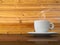 A white cup of coffee on wood table