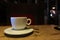 White cup in a dark cafe