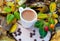 White cup with espresso on hemp among fallen autumn leaves