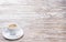 White cup espresso on light wooden background
