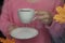 White cup in hand and window with raindrops.background blurred. selective focus.