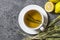 White cup of herbal sage tea with dried sage leaves and lemon on grey rustic background