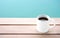 White cup of hot black coffee ceramic cup on the wood floor with