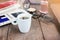 White cup hot black coffee on wood table with working women thin