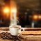 A white cup of hot coffee on wooden table with dark blurred background.